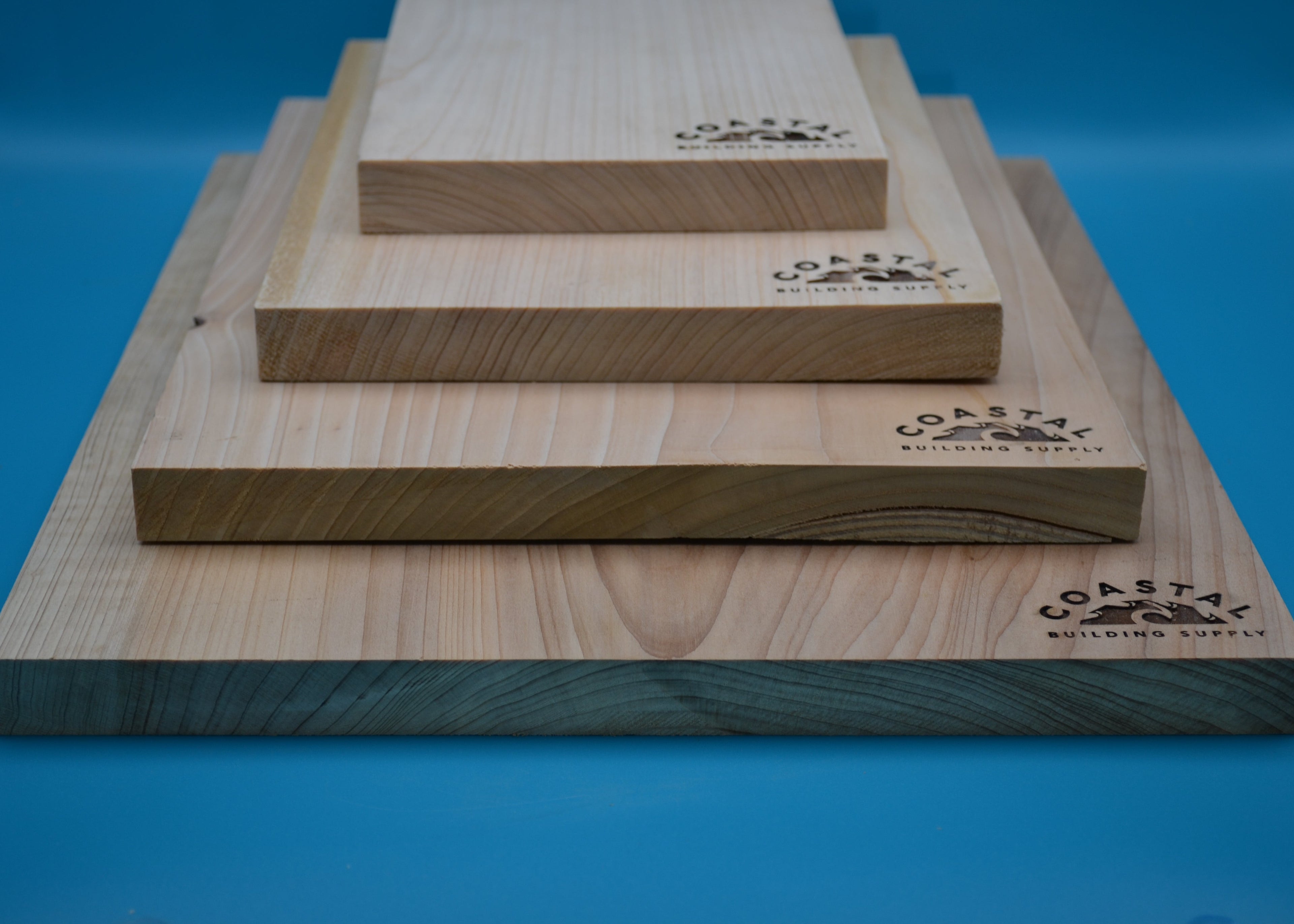 Stack of Cypress Select Boards on a blue background