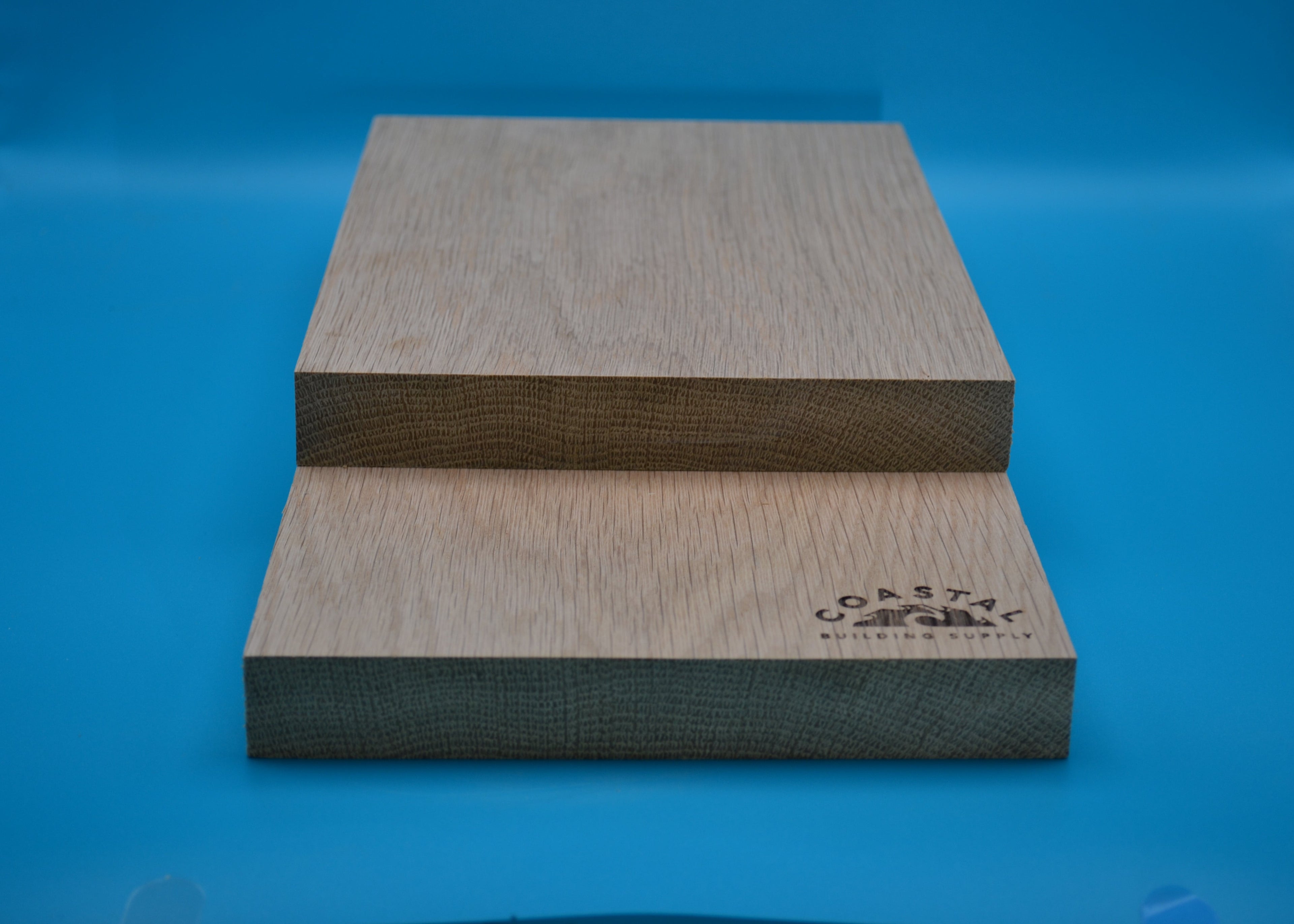 5/4 x 8 White Oak Wood planks on blue background