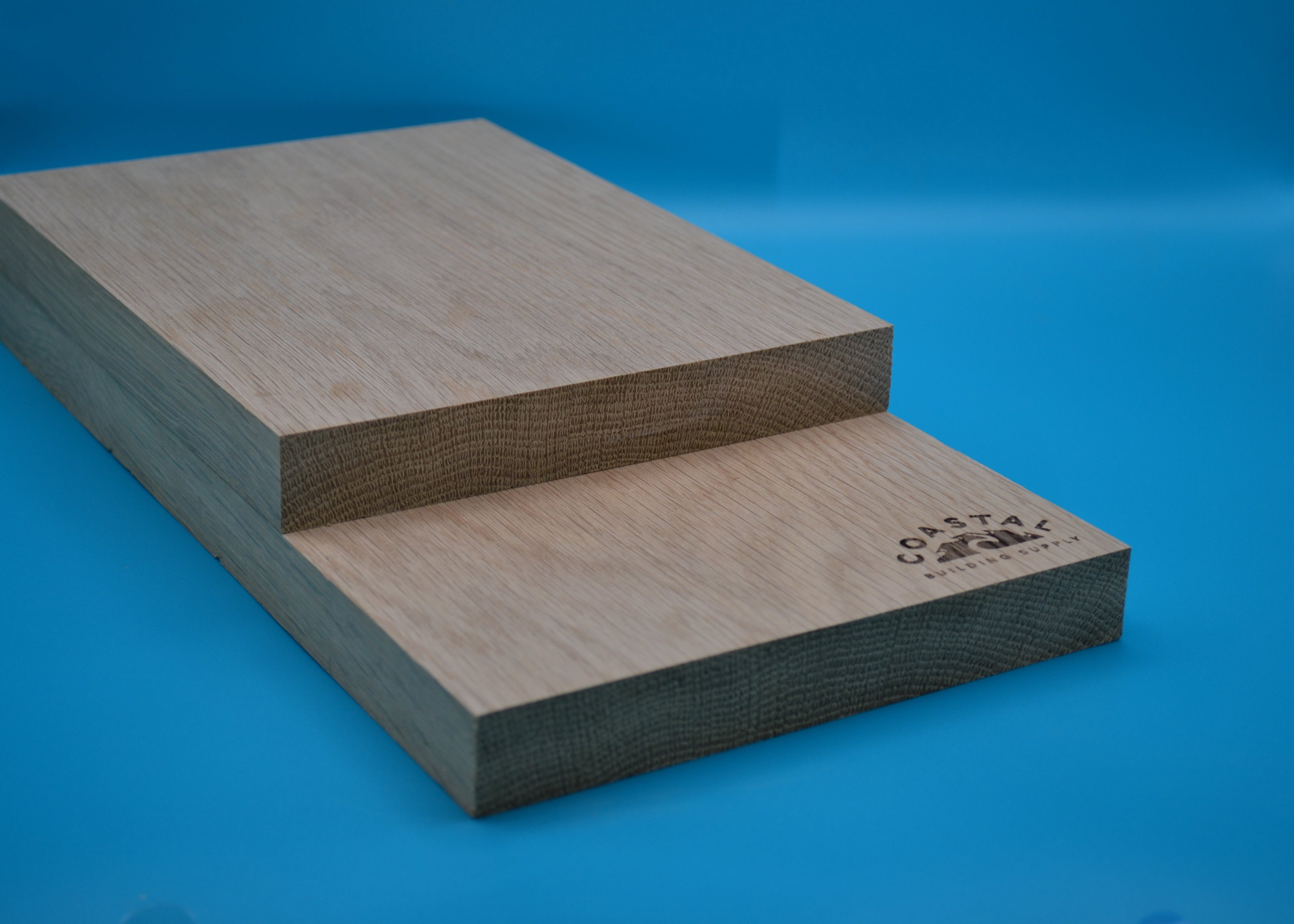 5/4 x 8 White Oak Wood planks on blue background