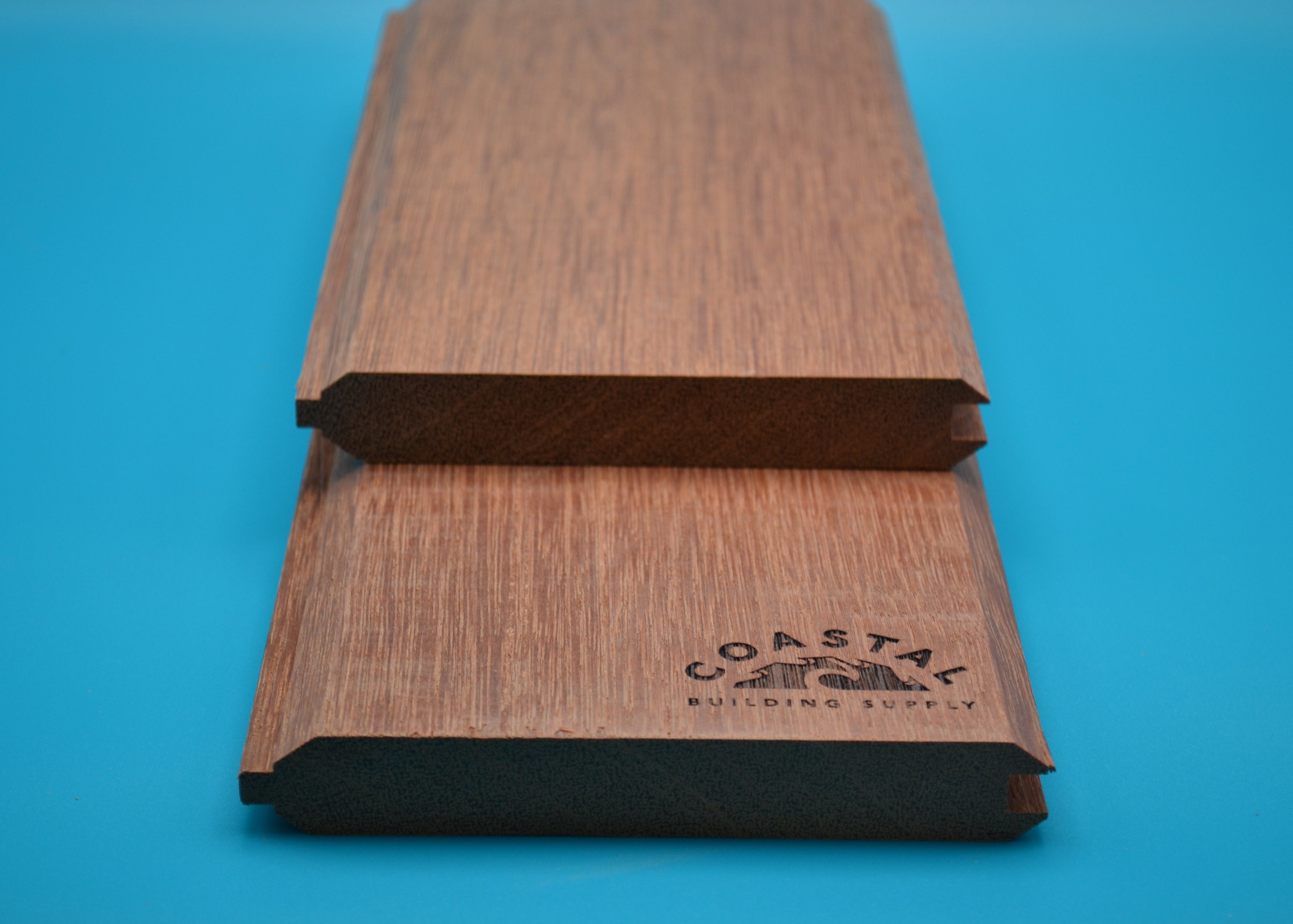 Red Balau 1x6 T&G V Groove Planks on blue background
