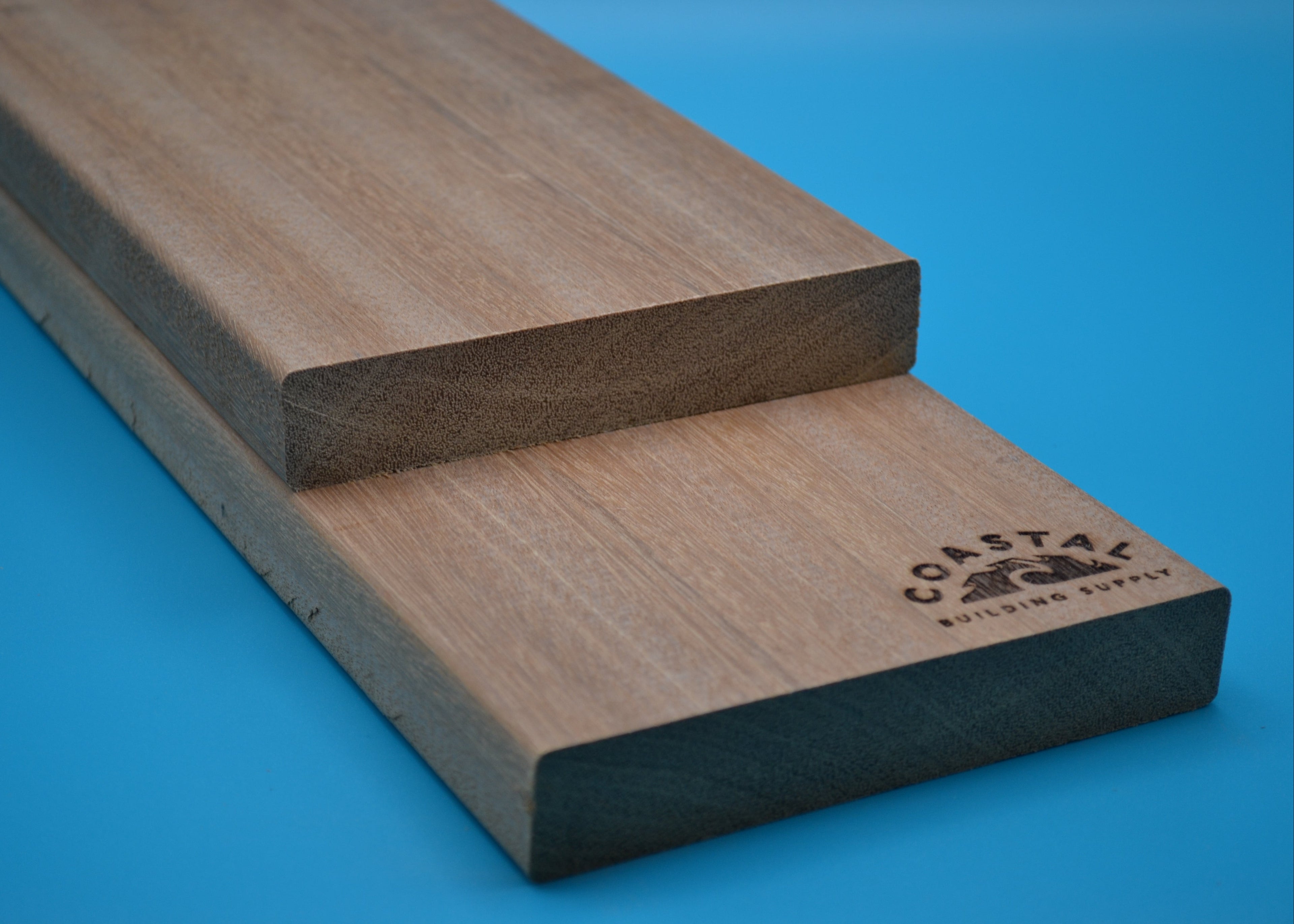 Yellow Balau 5/4x6 E4E Decking Planks on blue background