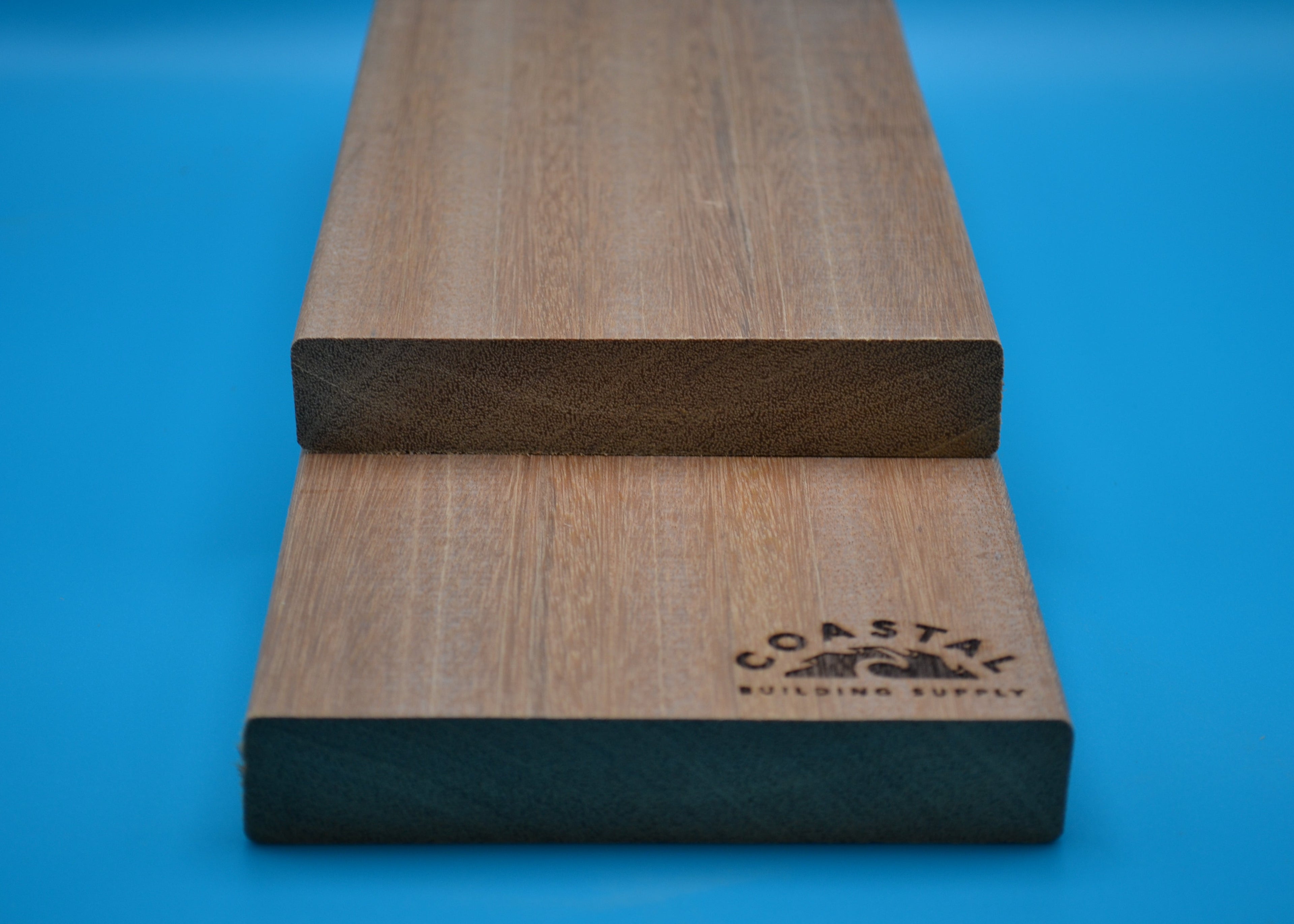 Yellow Balau 5/4x6 E4E Decking Planks on blue background