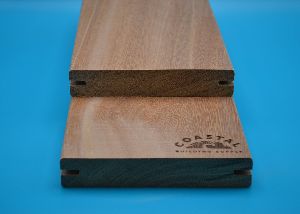 Yellow Balau 5/4x6 E4E Grooved Decking Planks on blue background