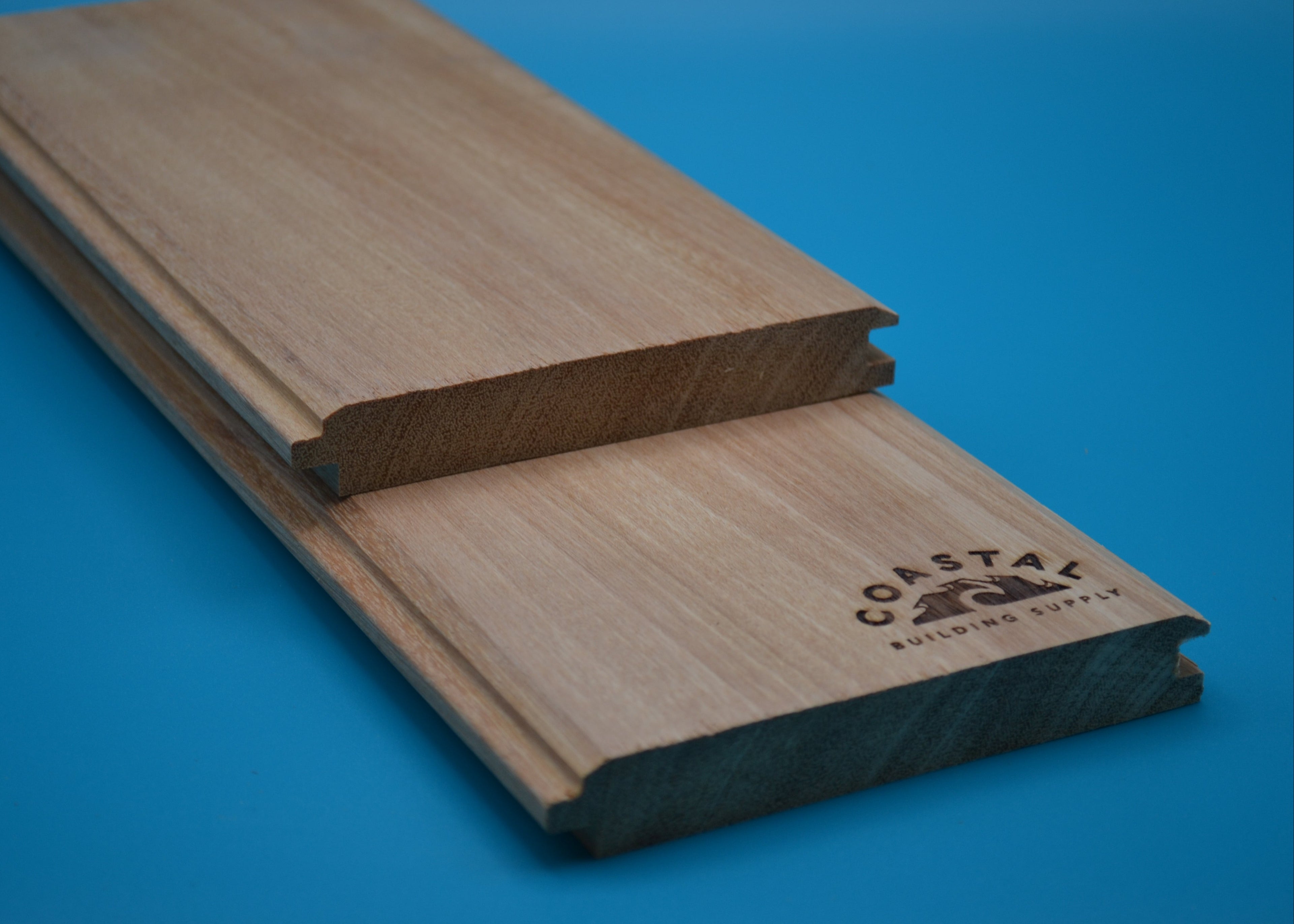 Yellow Balau 1x6 V-Lap Planks on blue background