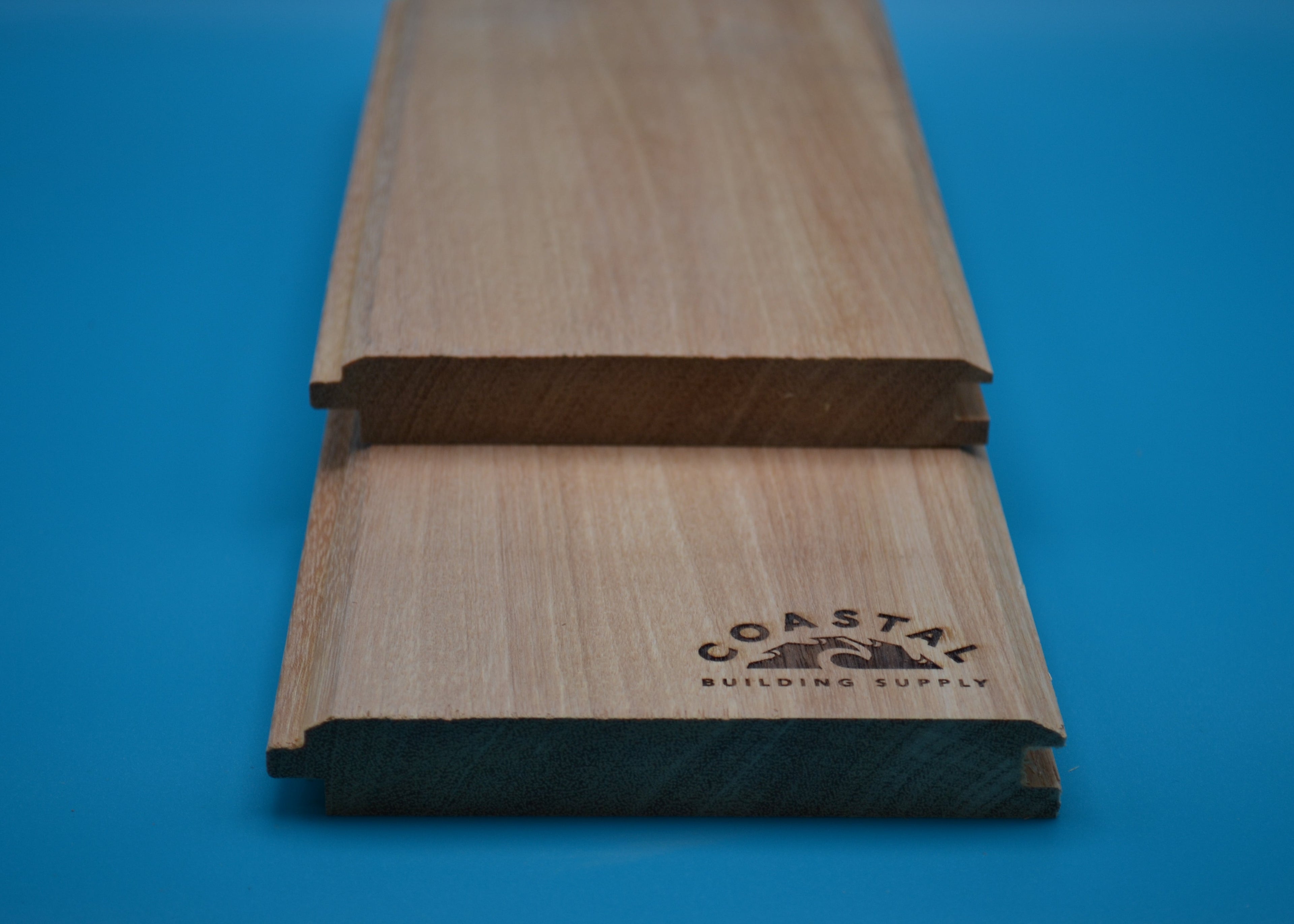 Yellow Balau 1x6 V-Lap Planks on blue background
