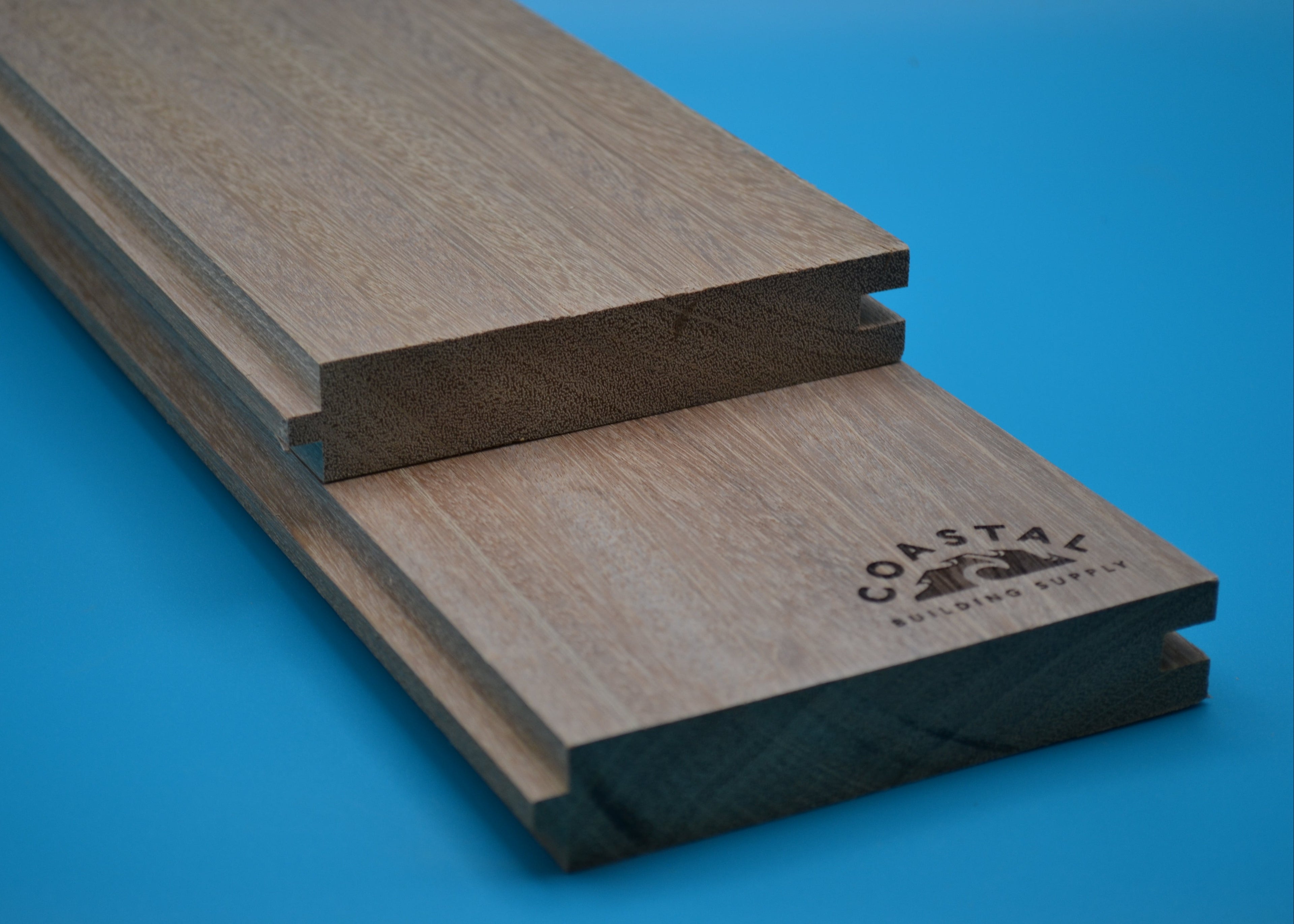Yellow Balau 5/4x6 T&G Flushgap Planks on blue background