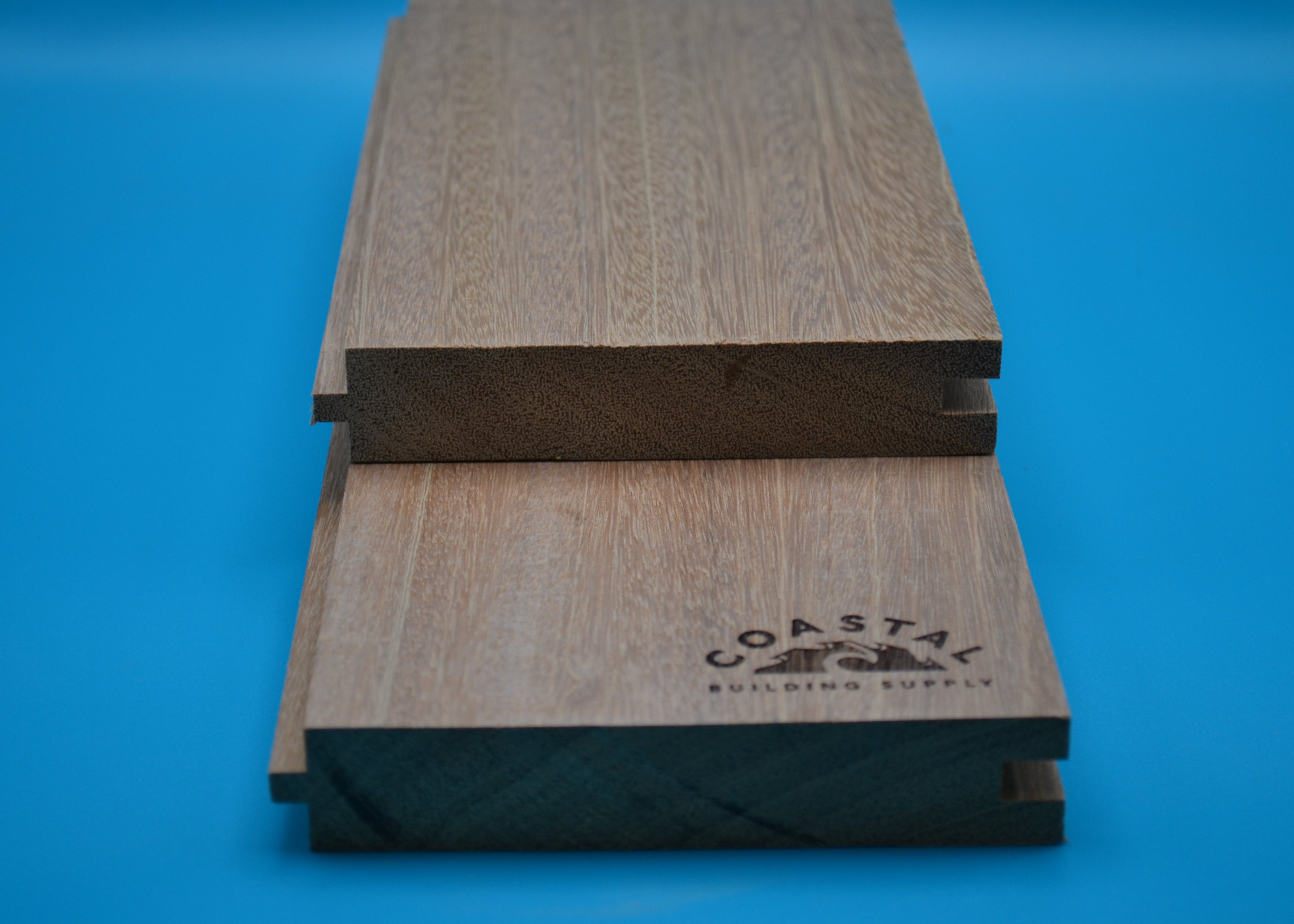 Yellow Balau 5/4x6 T&G Flushgap Planks on blue background